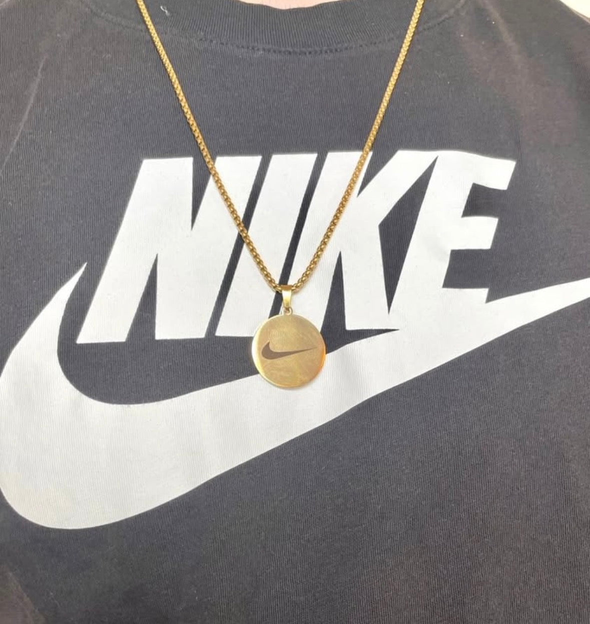Gold Nike pendent necklace